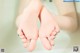 A close up of a woman's feet in a bathtub.